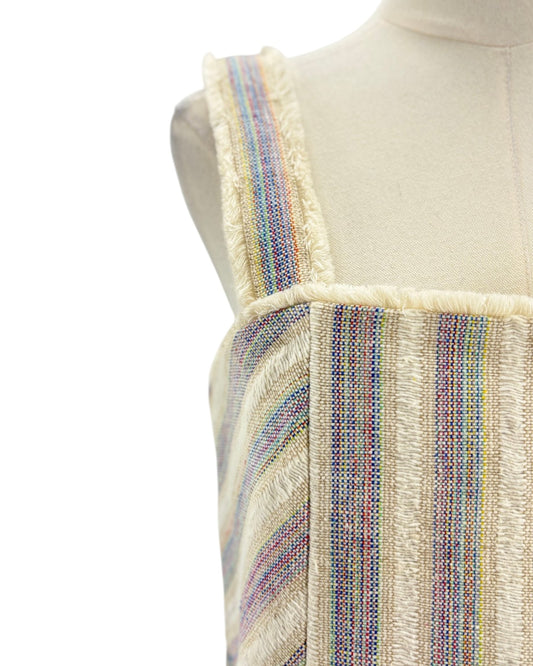 Mannequin wearing a colorful striped dress with a white background