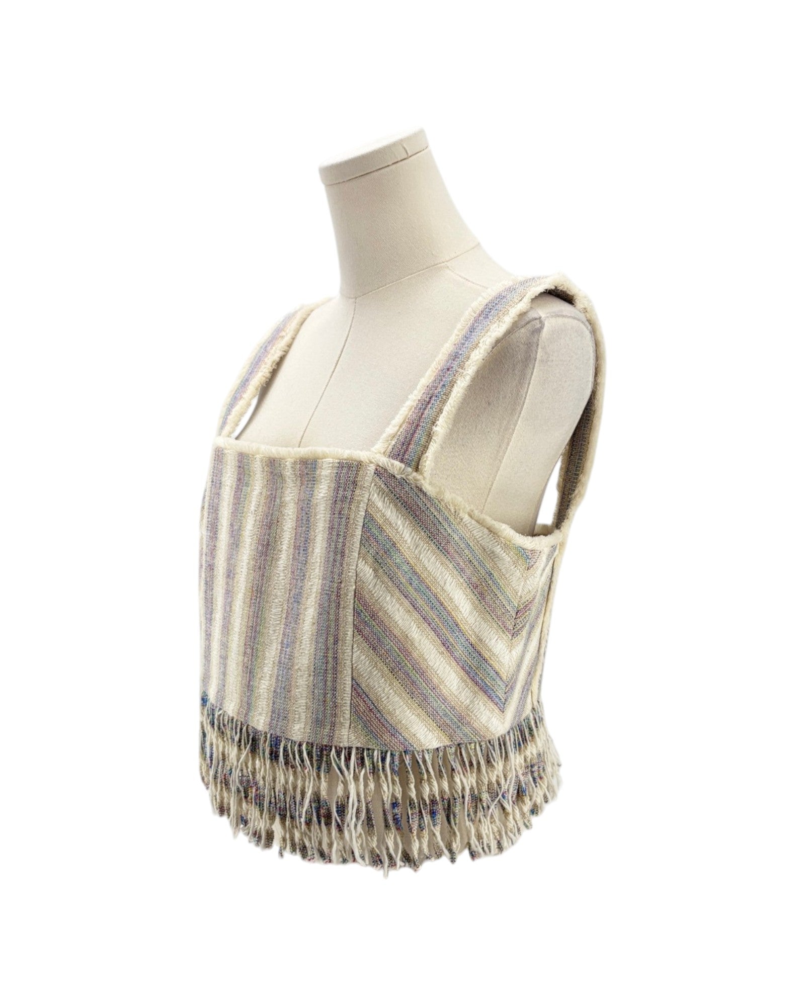 Striped top with fringes on a mannequin against a white background