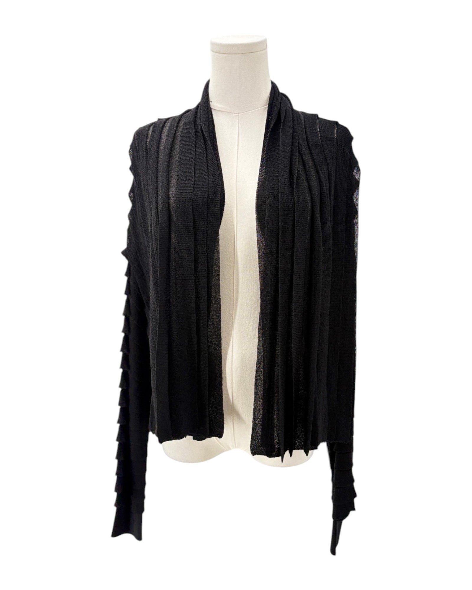 Black cardigan draped over a mannequin on a white background