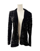 Black sequin blazer on a mannequin against a white background