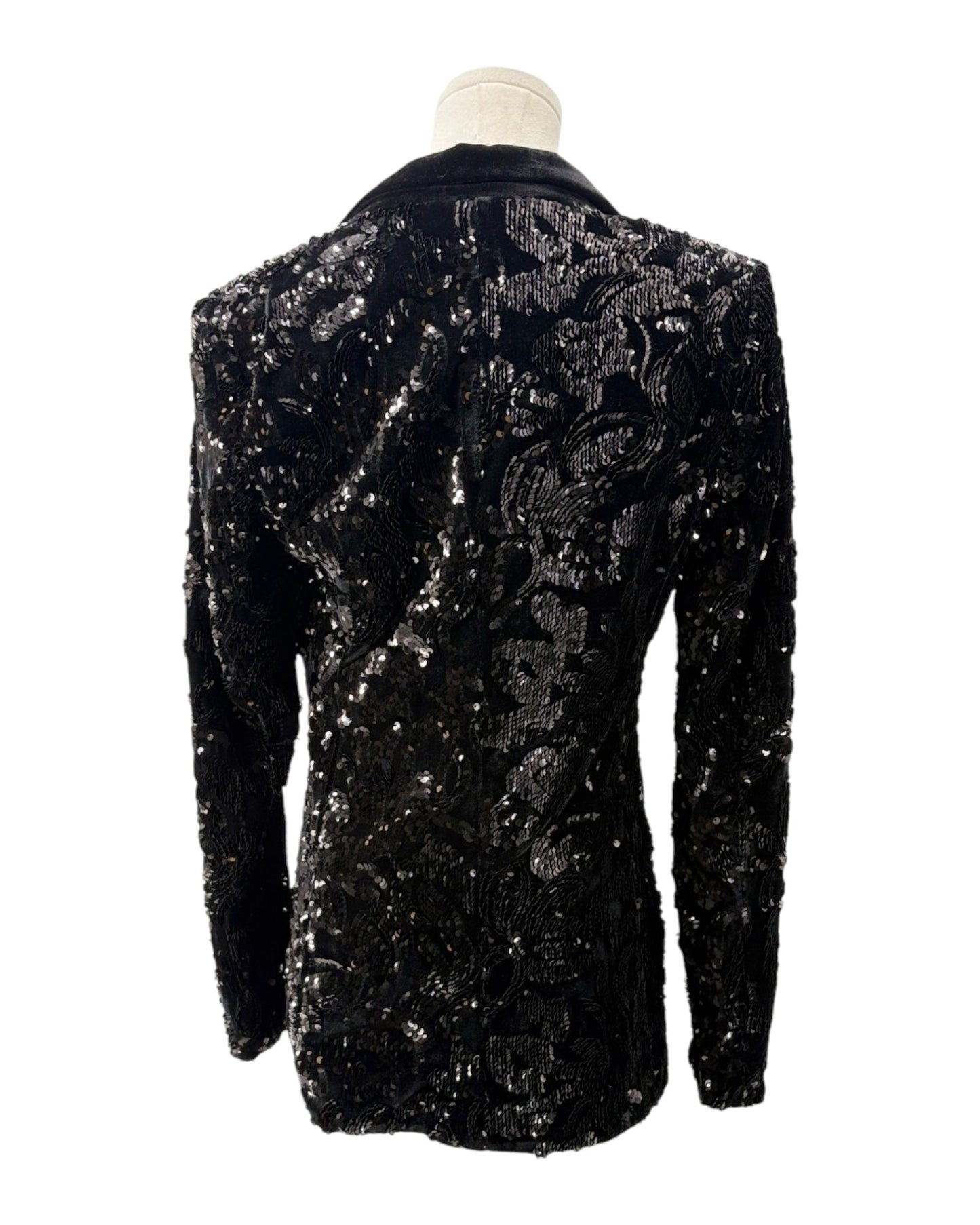 Black sequined jacket on a mannequin against a white background