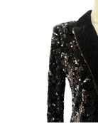 Black sequin pants on a mannequin against a white background