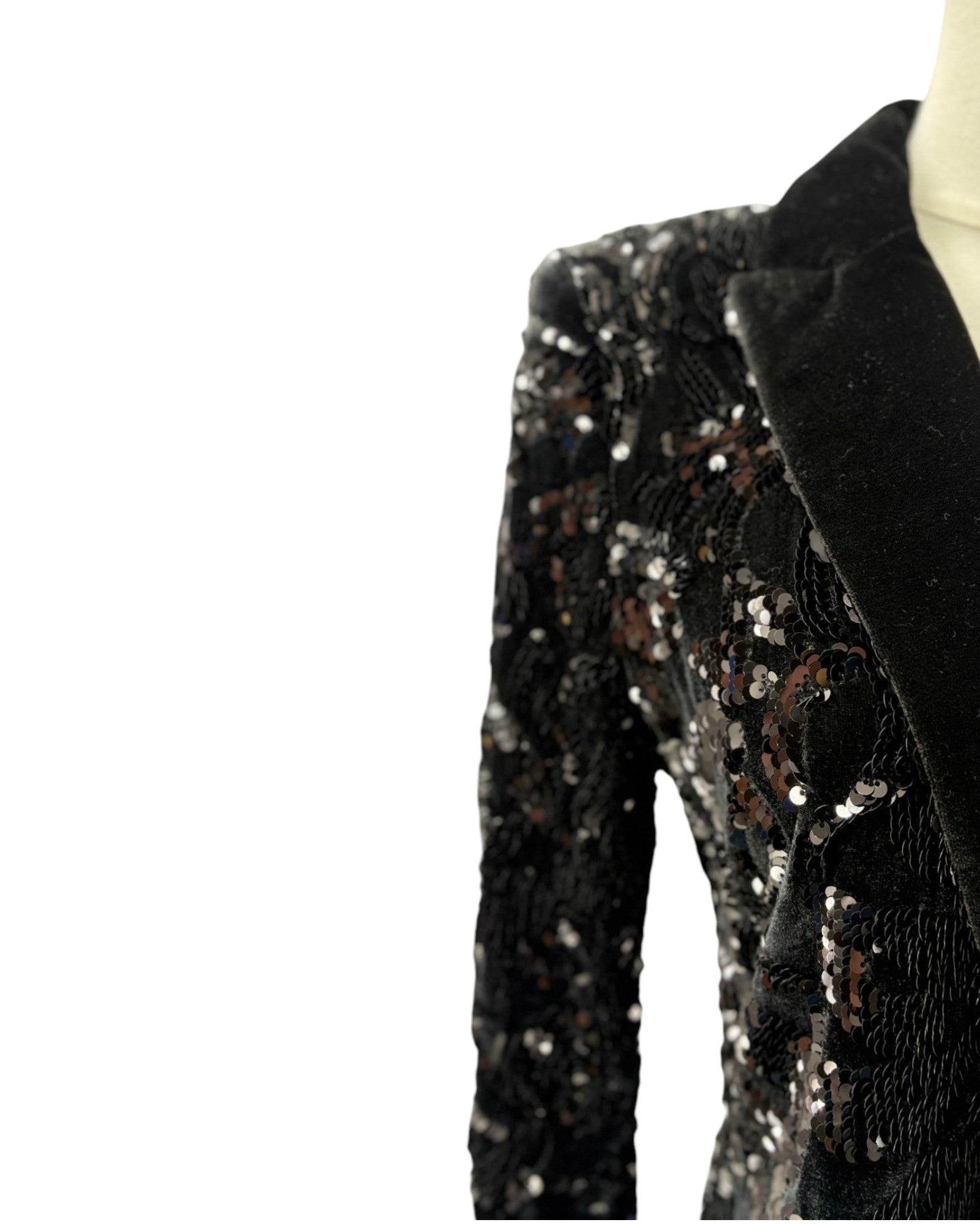 Black sequin pants on a mannequin against a white background