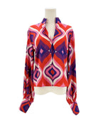 Colorful patterned shirt on a mannequin against a white background