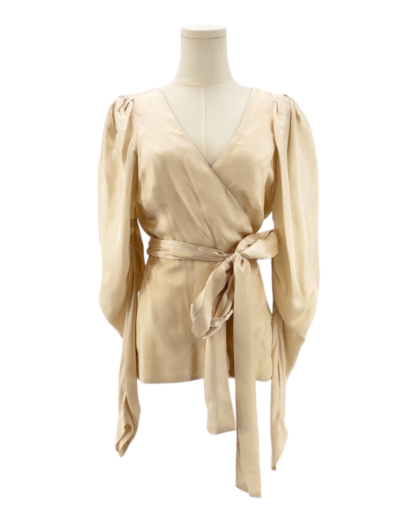 Beige wrap top on a mannequin against a white background