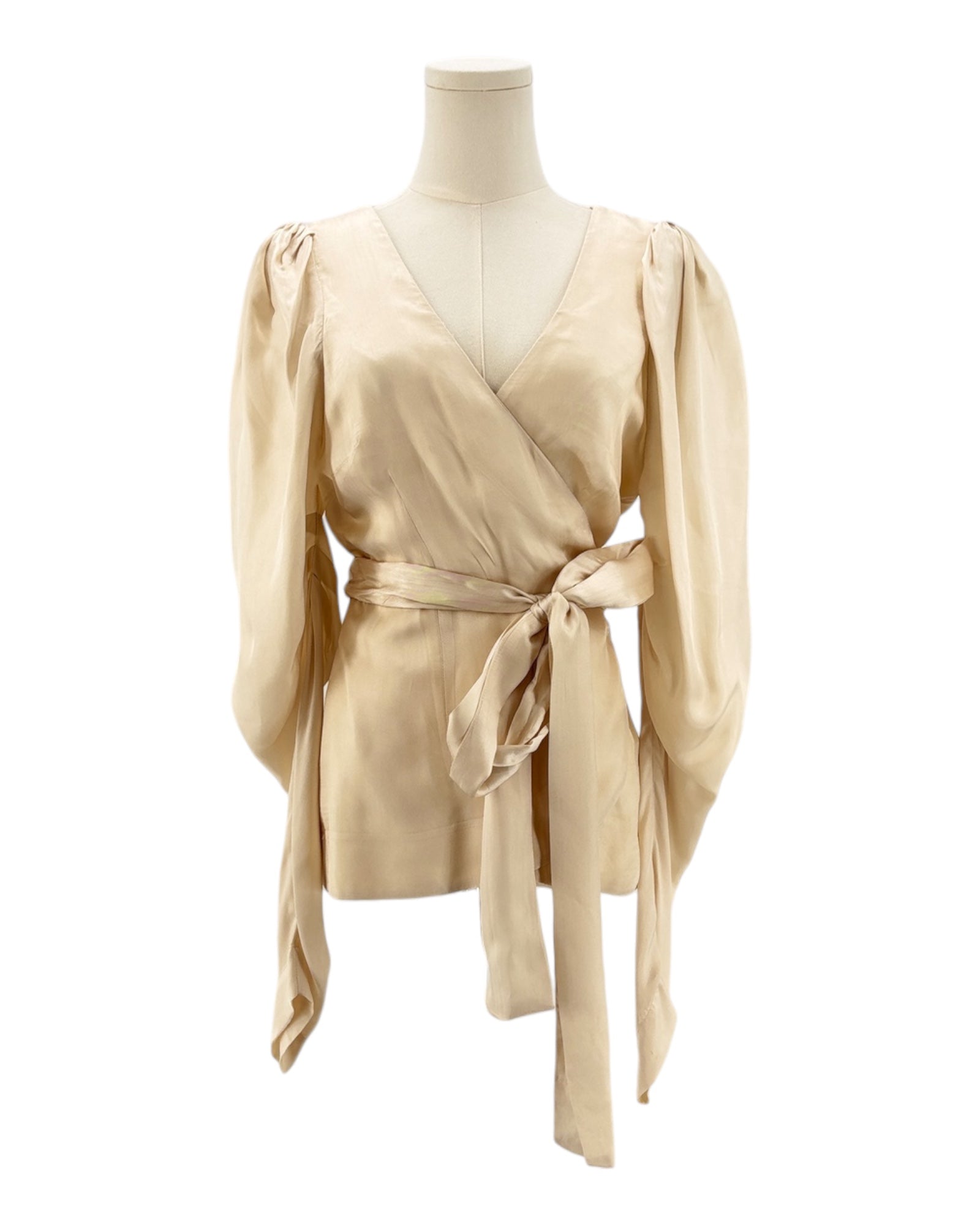 Beige wrap top on a mannequin against a white background