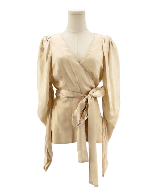 Beige wrap top on a mannequin against a white background