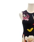 Dress with floral and butterfly design on a mannequin against a white background
