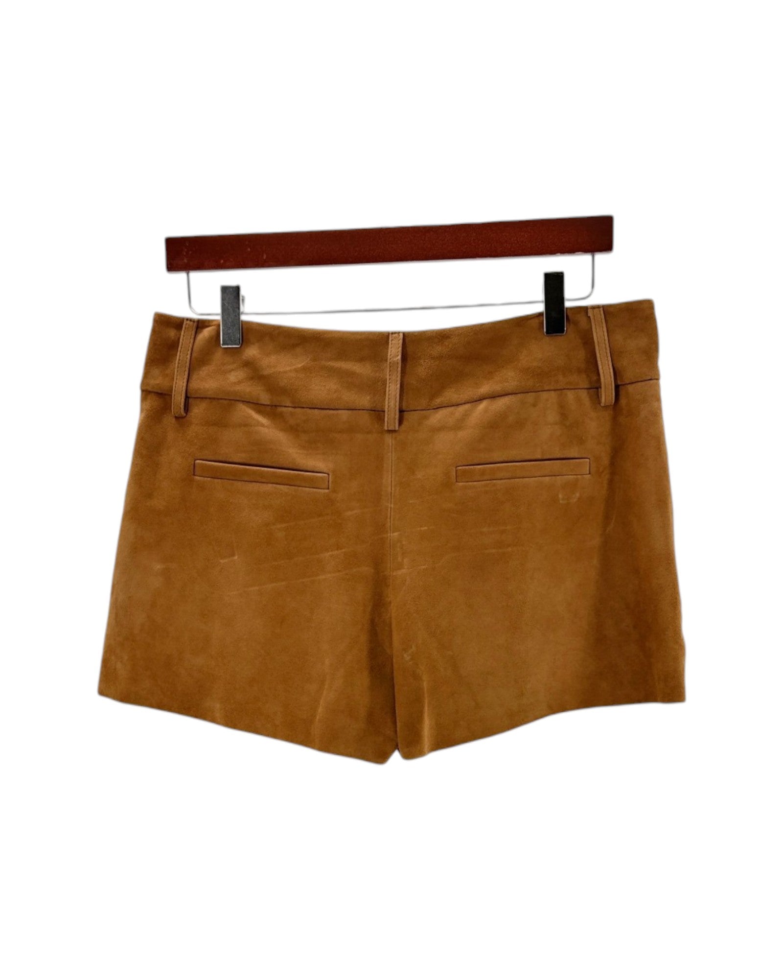 Brown shorts on a hanger against a white background