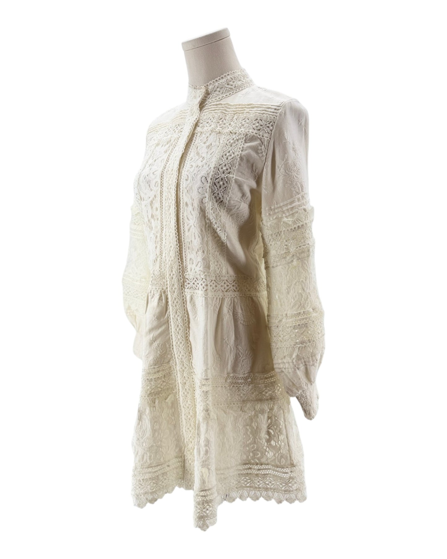 White lace blouse on a mannequin against a white background
