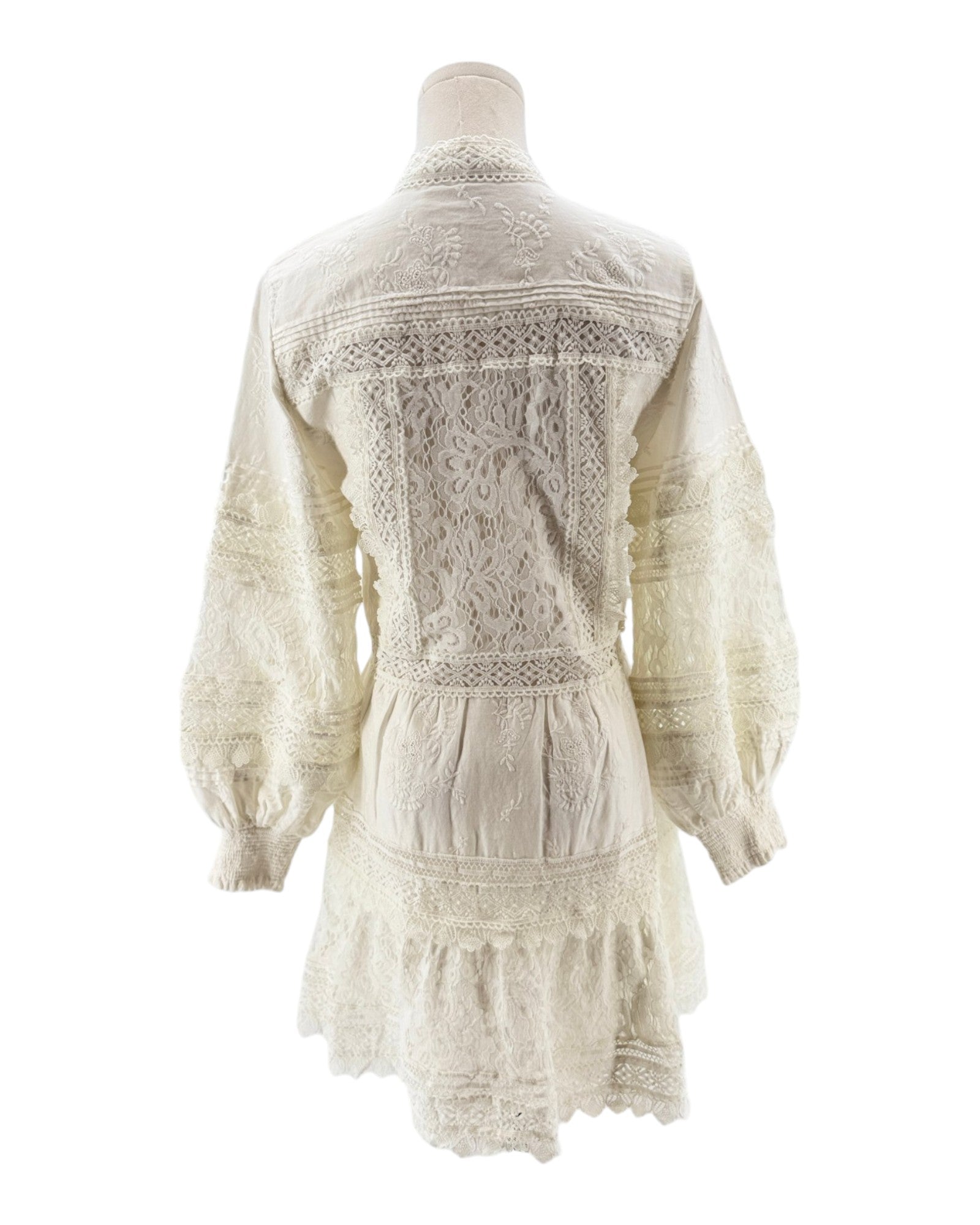 White lace dress on a mannequin against a white background
