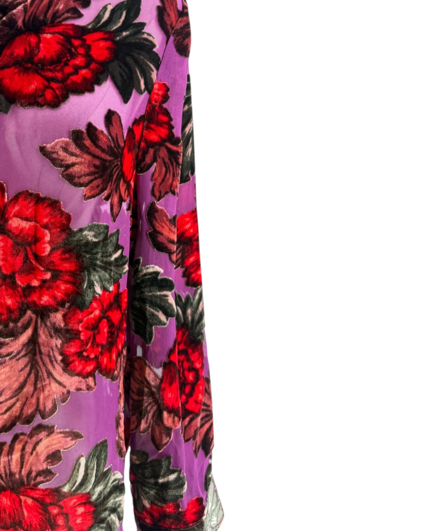 Close-up of a floral pattern with red flowers and green leaves on a purple background.