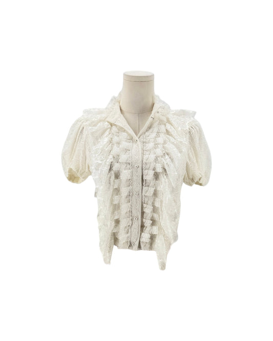 An off-white lace short-sleeve blouse with textured ruffles and a high collar, displayed on a cream mannequin torso against a plain white background.