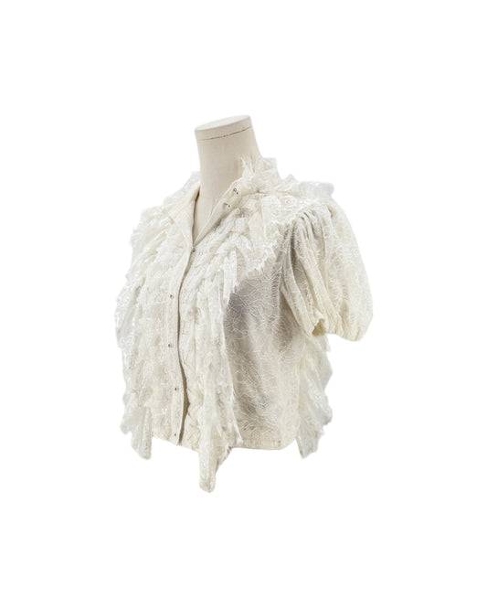 An off-white textured lace short-sleeve blouse with ruffled trim, displayed on a cream mannequin torso against a plain white background.