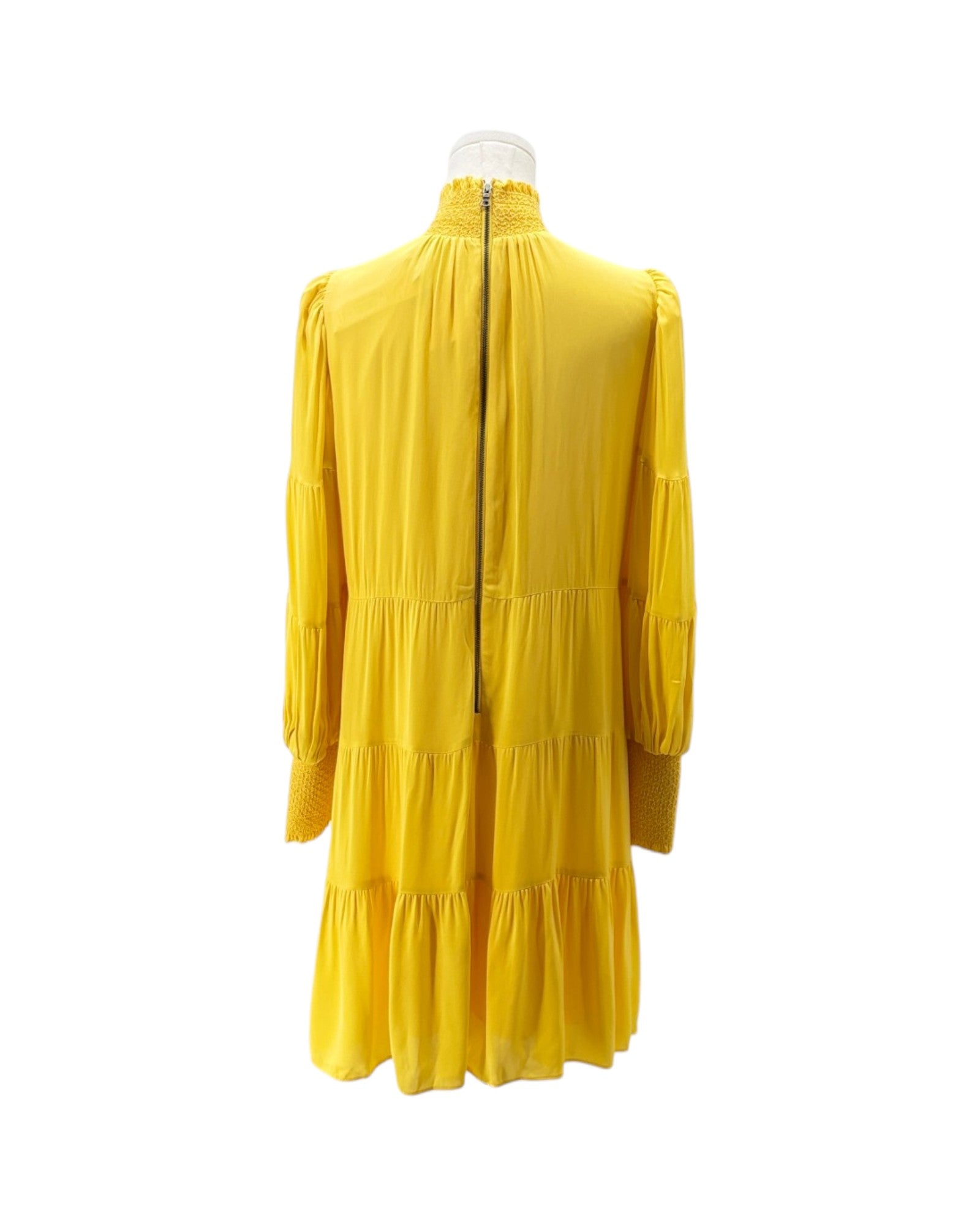 Yellow dress on a mannequin against a white background