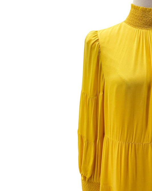 Yellow dress with smocked neckline on a white background