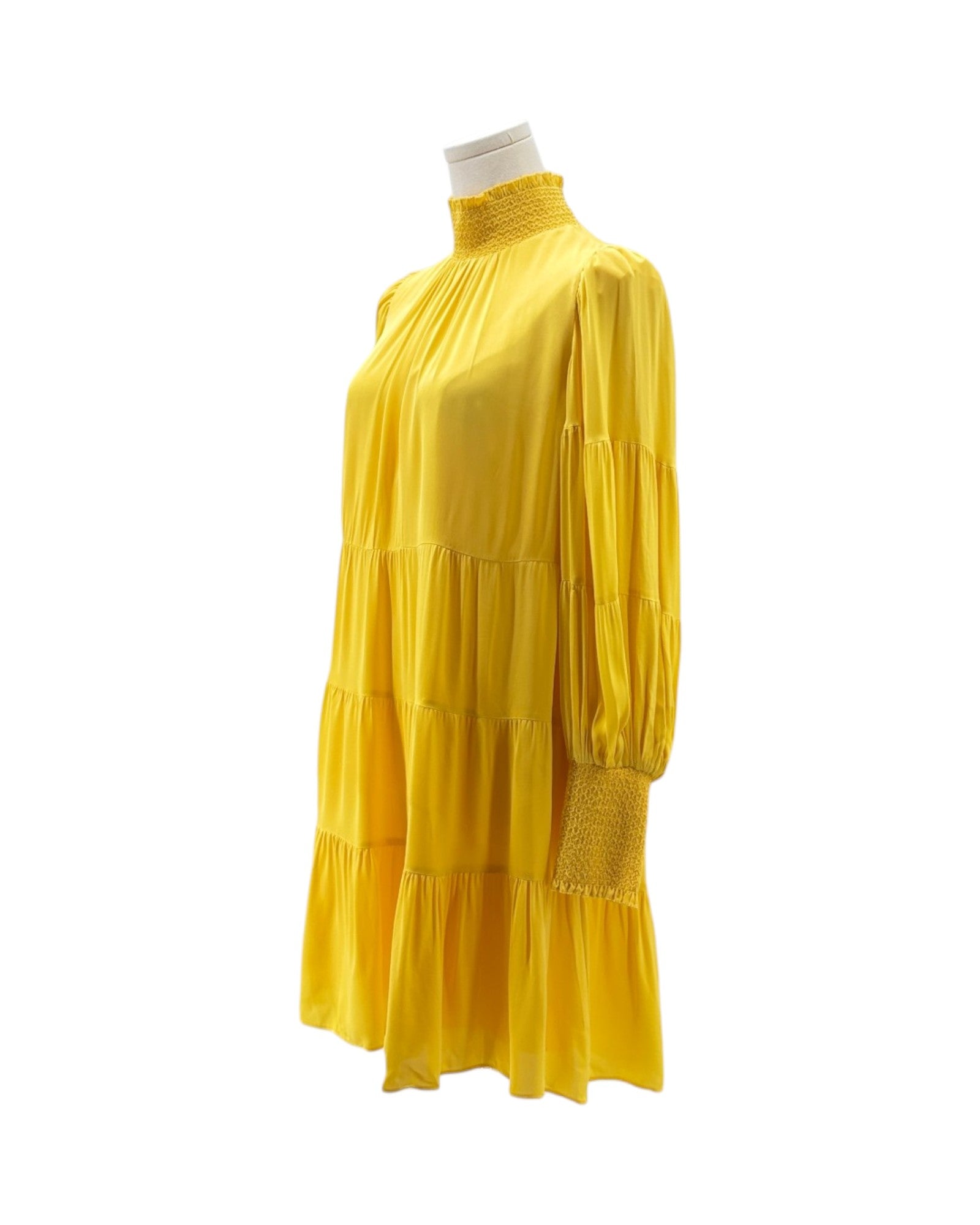 Yellow dress on a mannequin against a white background