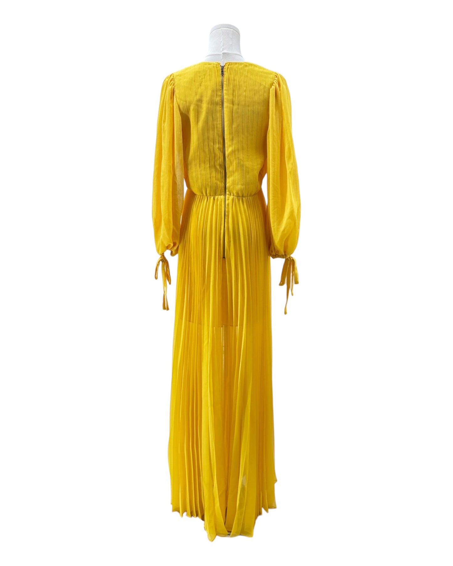 Yellow dress on a mannequin against a white background