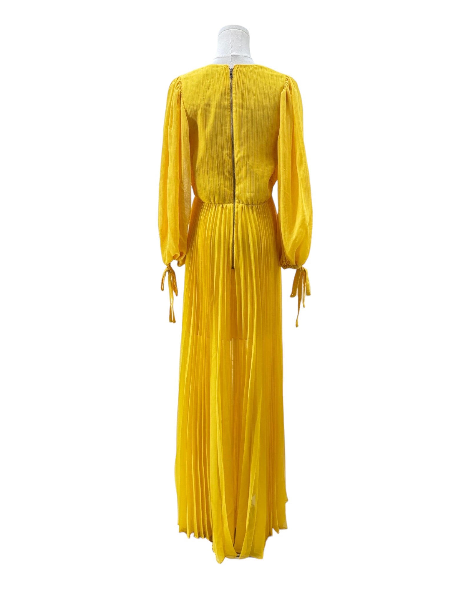 Yellow dress on a mannequin against a white background