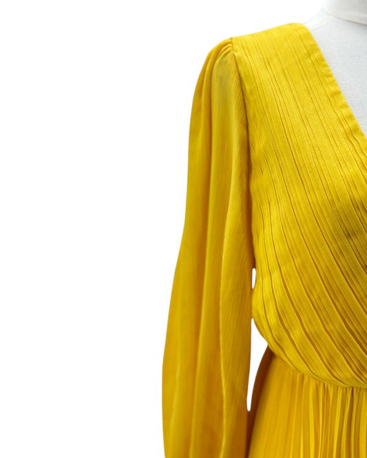 Yellow pleated garment on a white background
