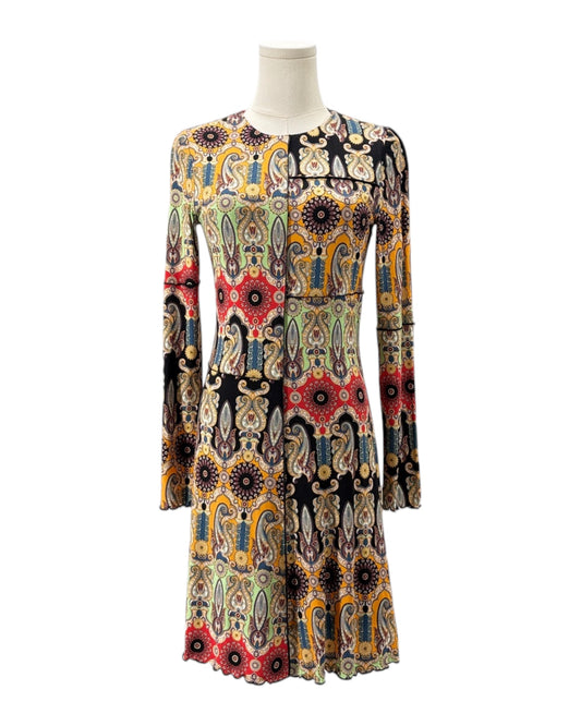 Colorful patterned dress on a mannequin against a white background