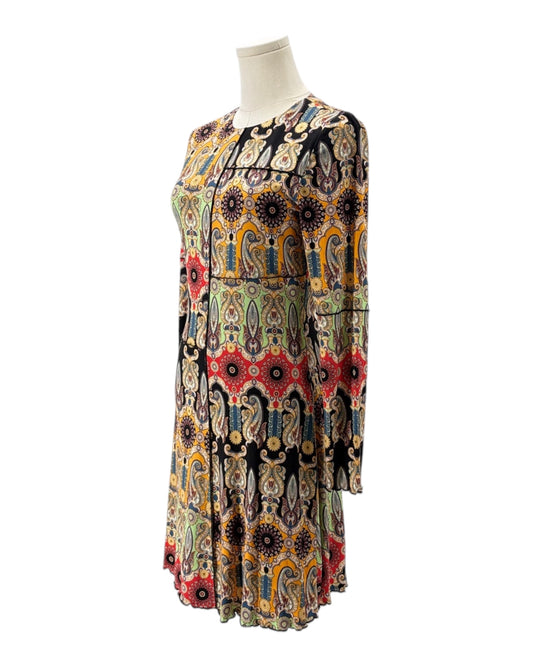 Colorful patterned dress on a mannequin against a white background