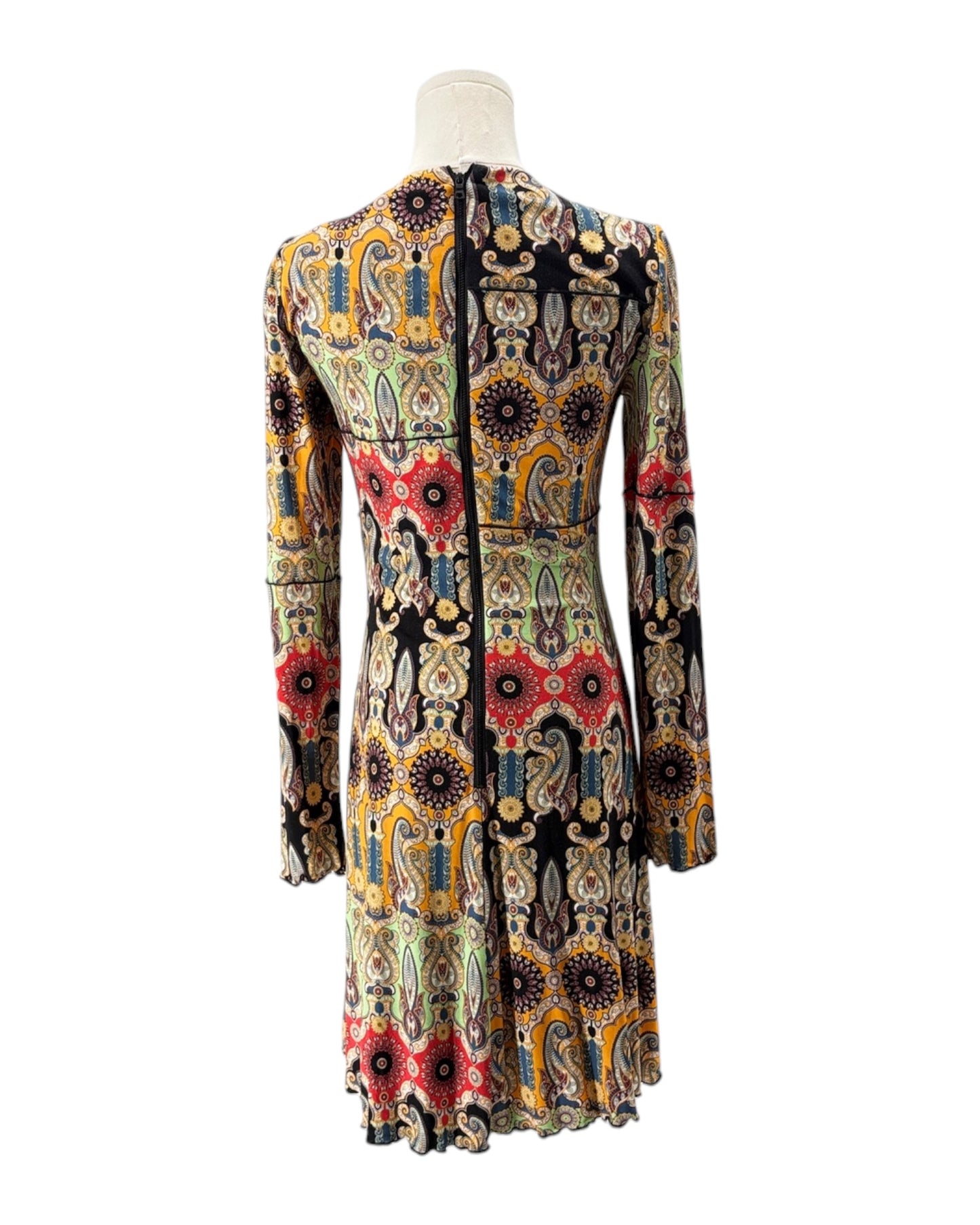 Colorful patterned dress on a mannequin against a white background