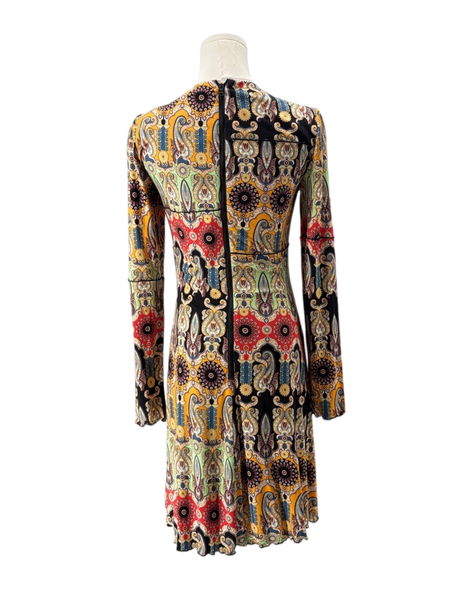 Colorful patterned dress on a mannequin against a white background