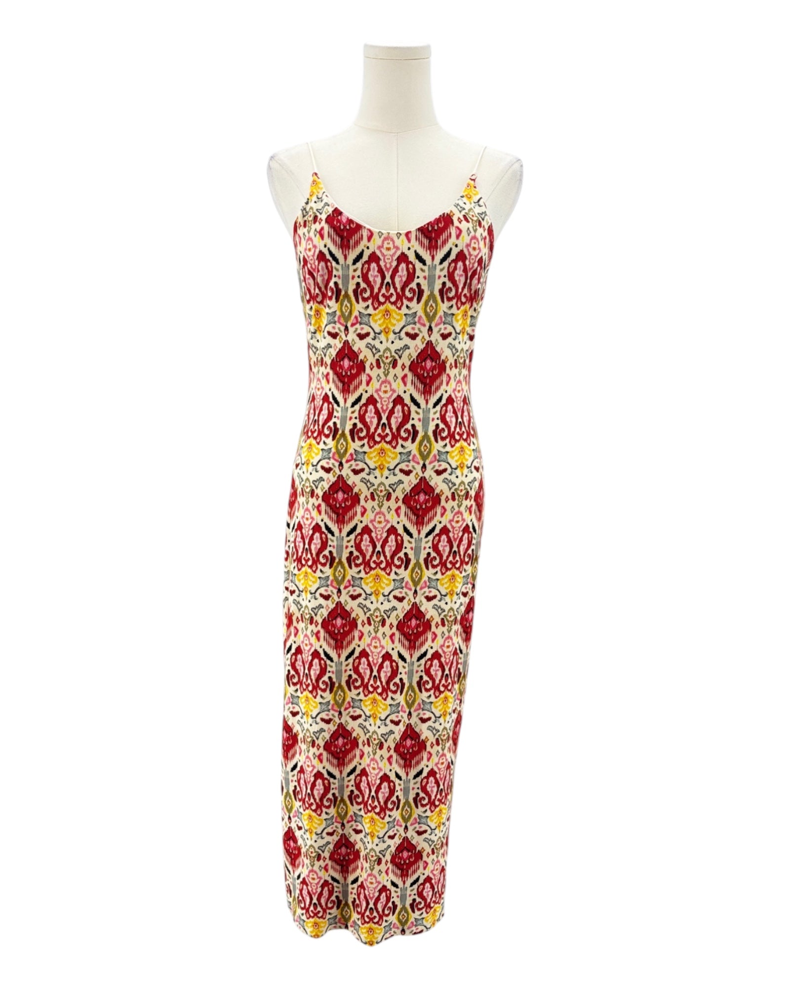 Colorful patterned dress on a mannequin against a white background