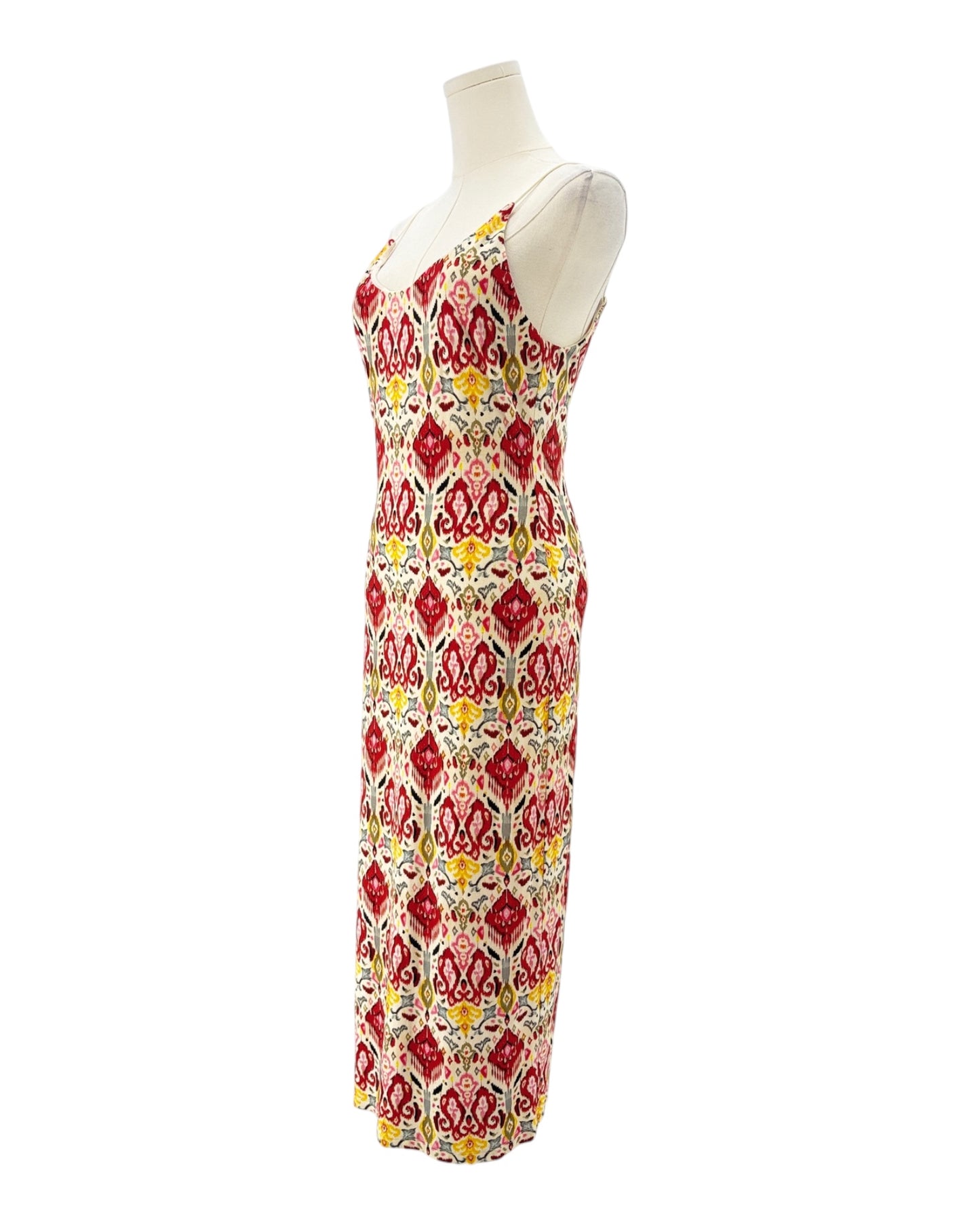 Colorful patterned dress on a mannequin against a white background