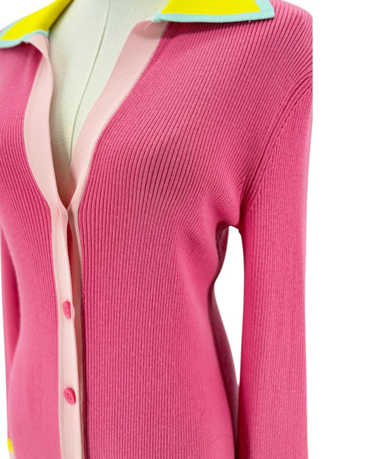 Pink ribbed long sleeve midi dress with yellow details on the collar and cuffs. On and white background on a mannequin