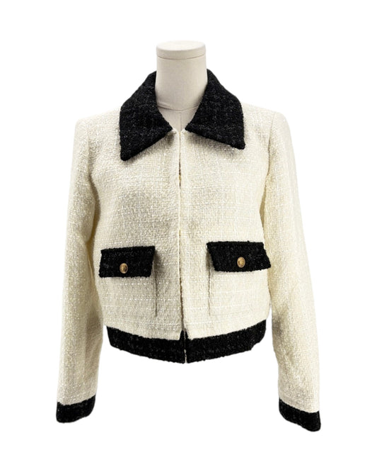 White jacket with black trim on a mannequin against a white background