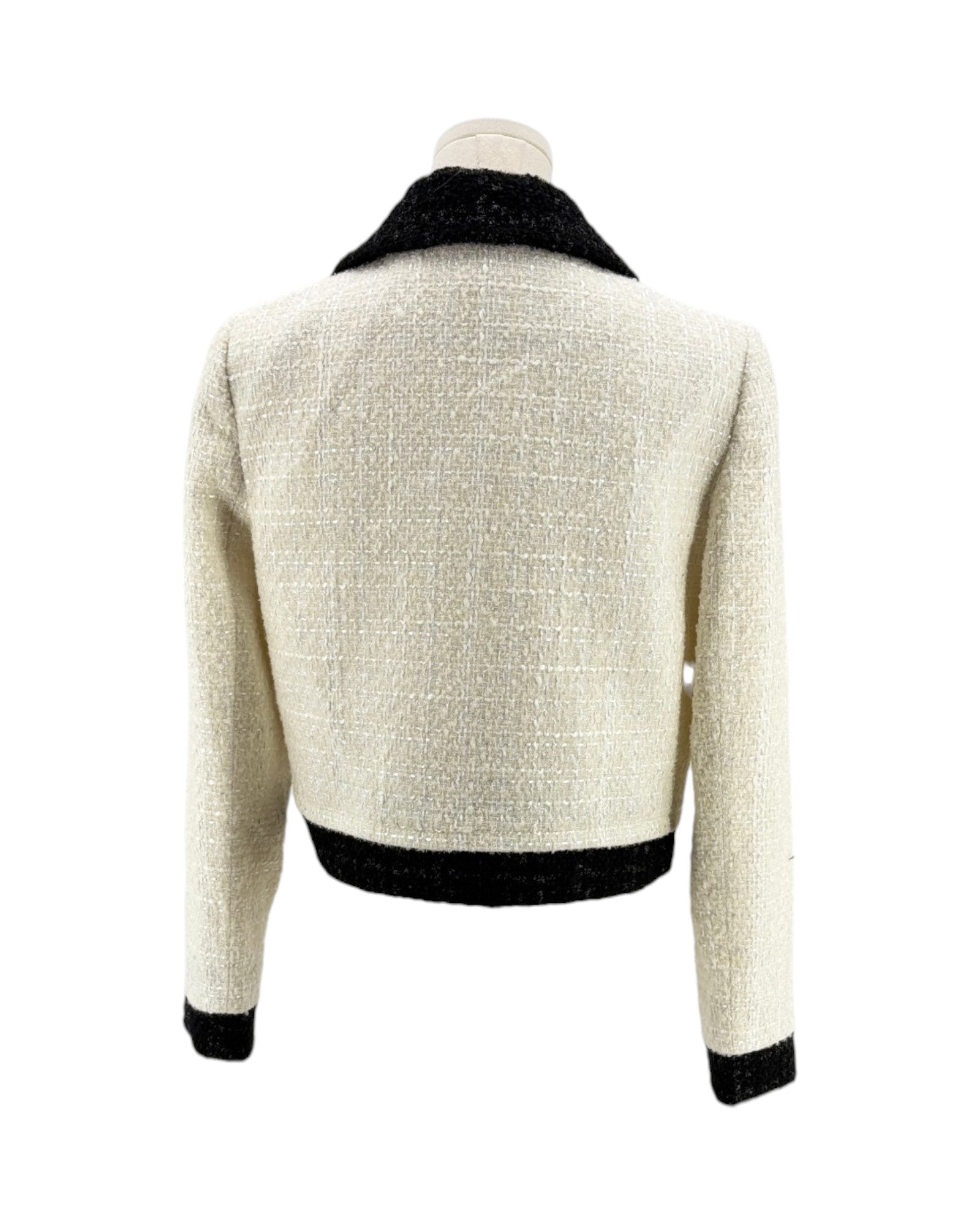 Back view of a white textured jacket with black trim on a white background