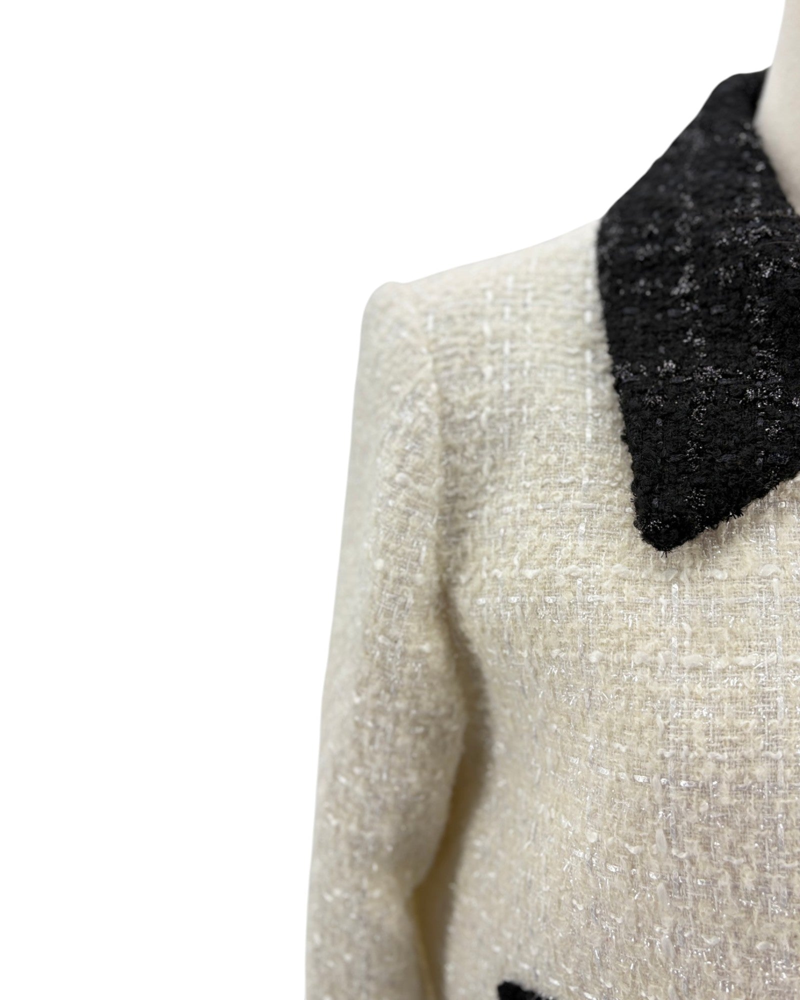 Close-up of a textured sweater with a black collar on a white background