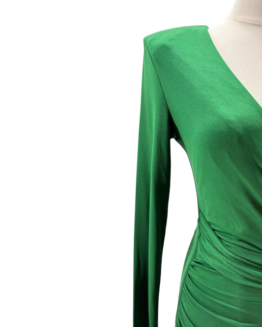 Green dress on a mannequin with a white background