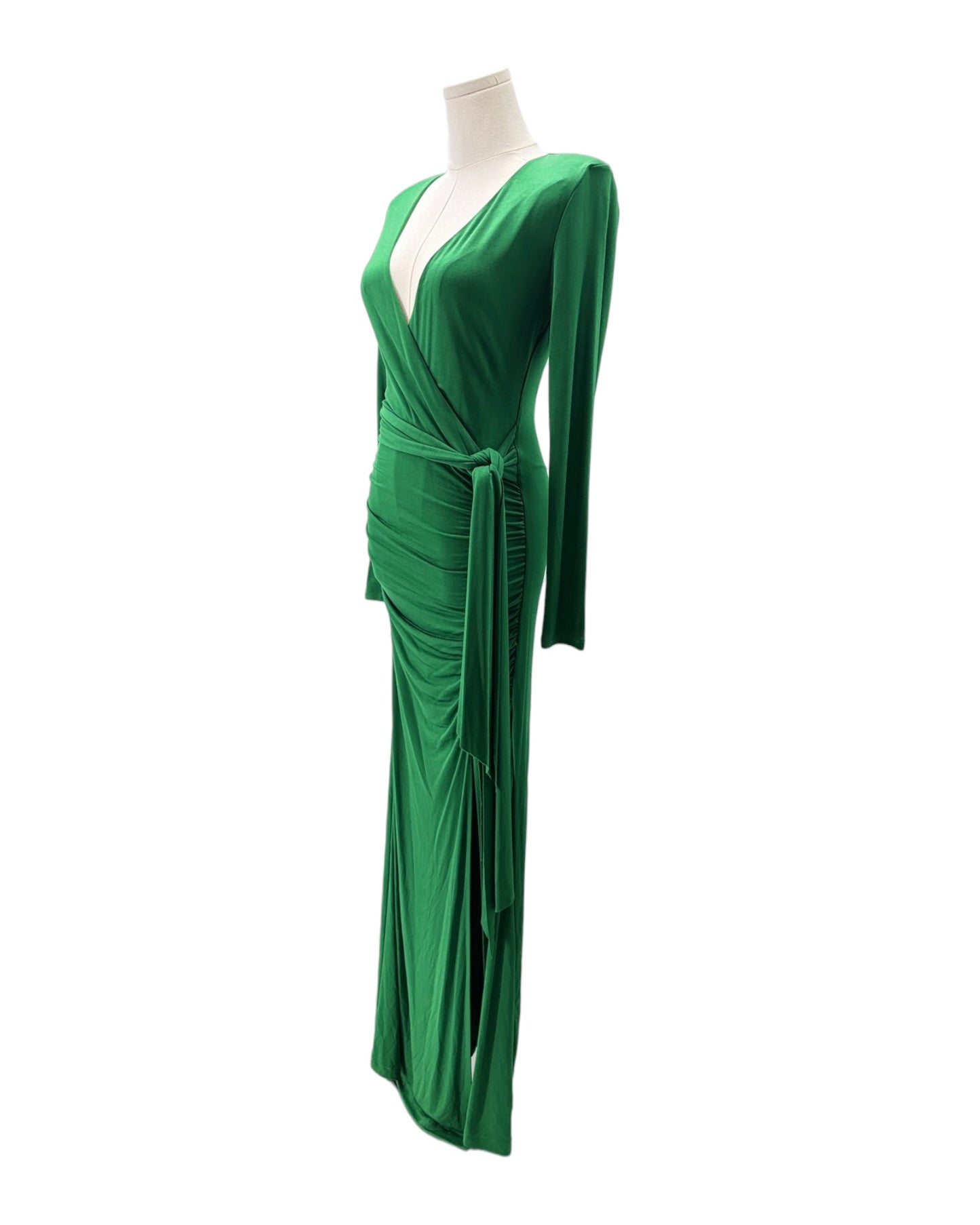 Green evening gown on a mannequin against a white background