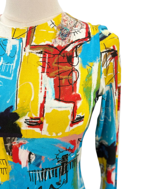 Colorful abstract patterned dress on a mannequin against a white background