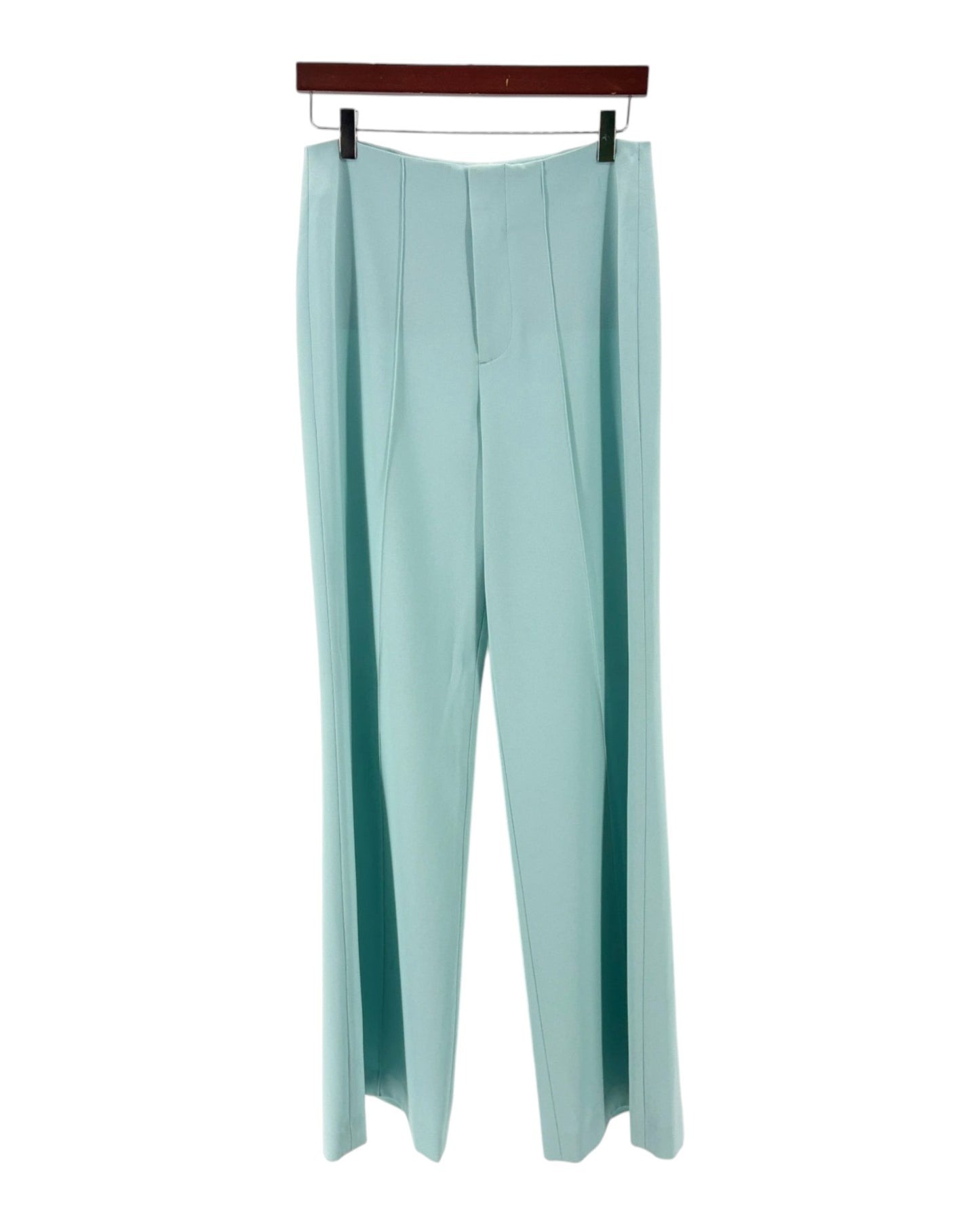 Light blue pants on a hanger against a white background