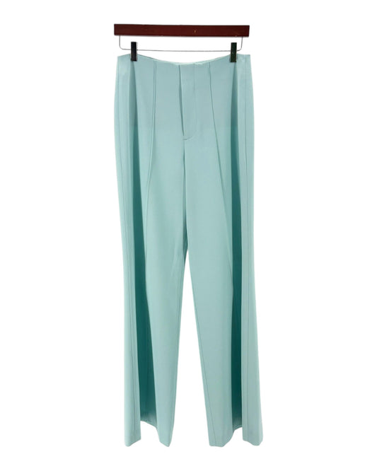 Light blue pants on a hanger against a white background