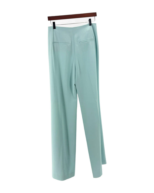 Light blue pants on a hanger against a white background
