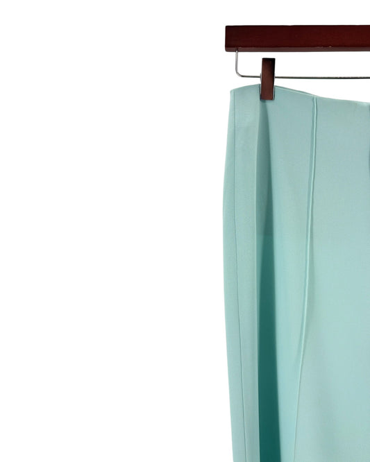 Light blue dress hanging on a wooden hanger against a white background