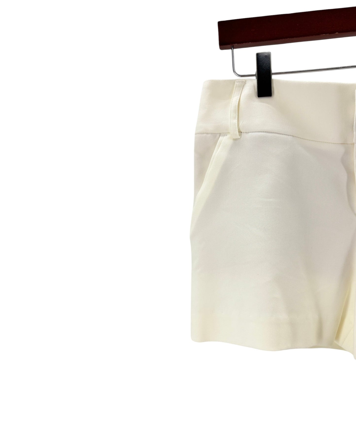White shorts on a hanger against a white background