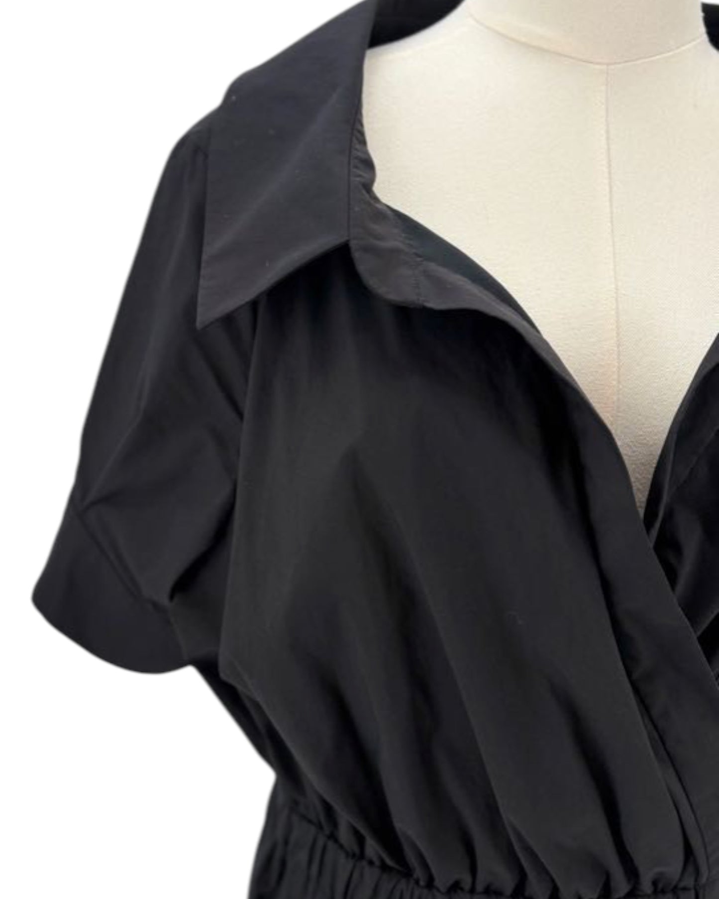 Black dress on a mannequin with a white background