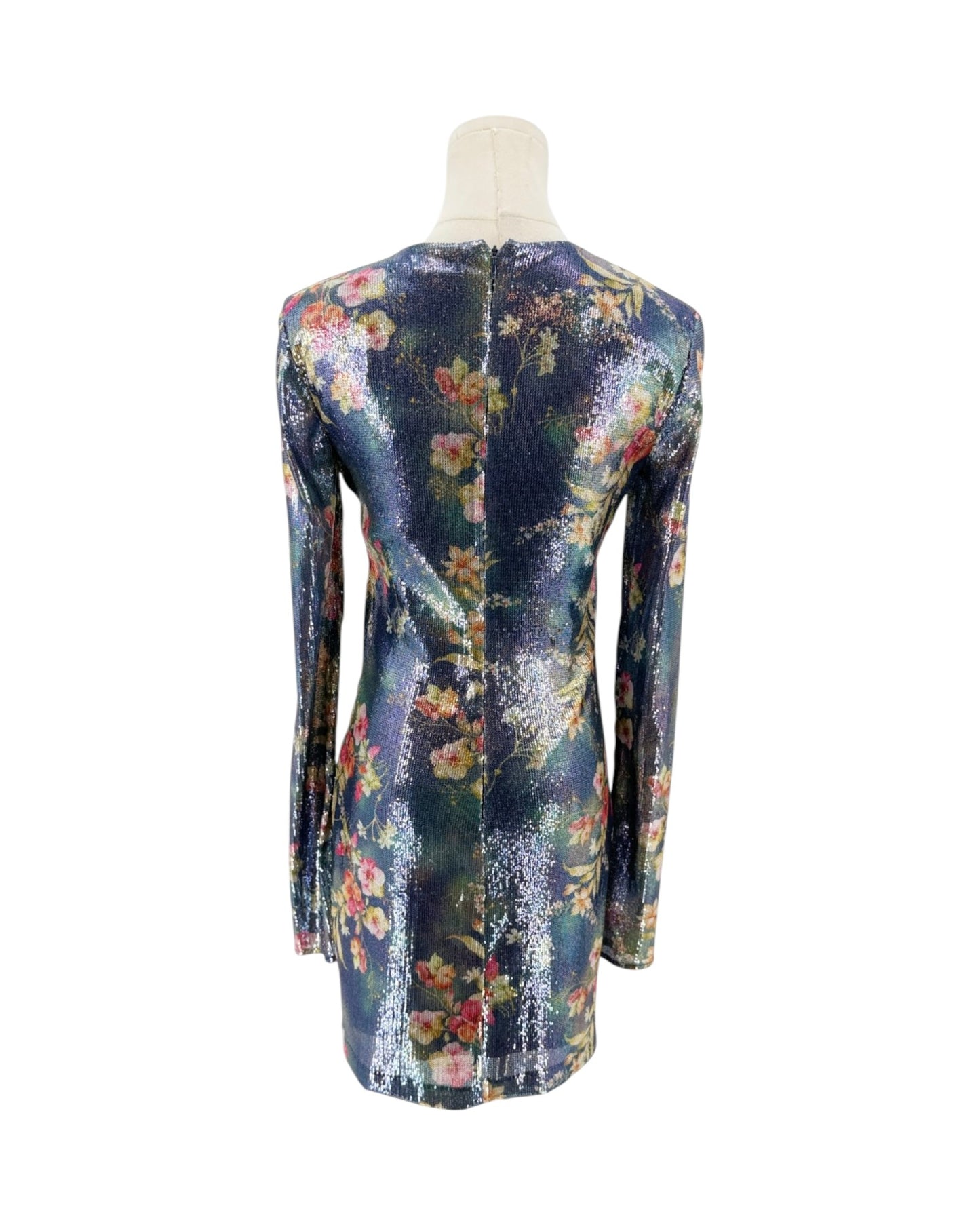 A long-sleeve mini dress with a dense floral print, displayed on a mannequin from the back against a plain white background.