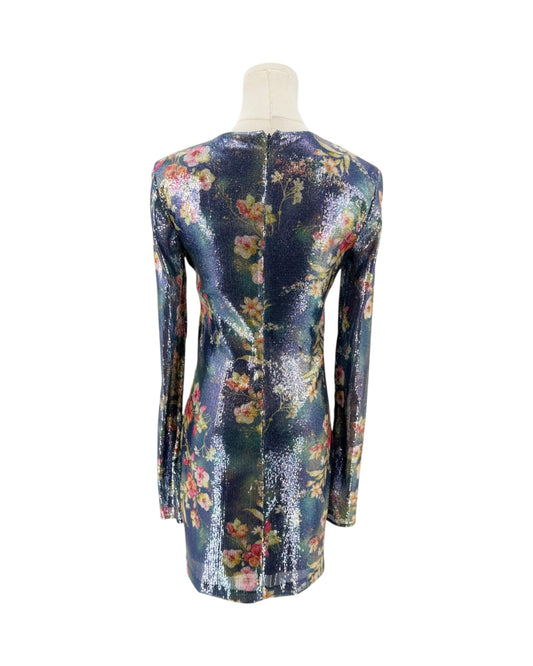 A long-sleeve mini dress with a dense floral print, displayed on a mannequin from the back against a plain white background.