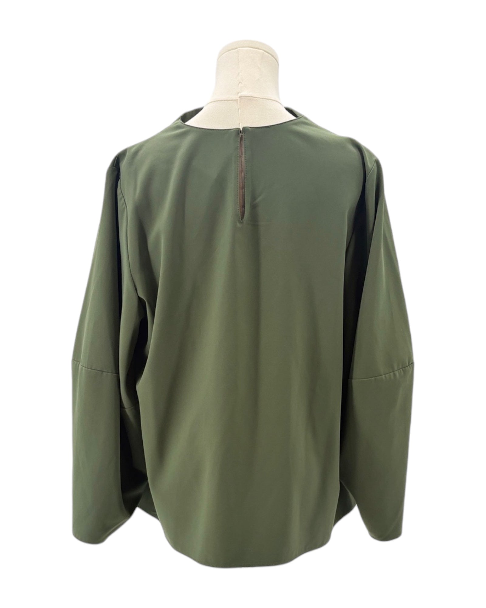 Green blouse on a mannequin against a white background