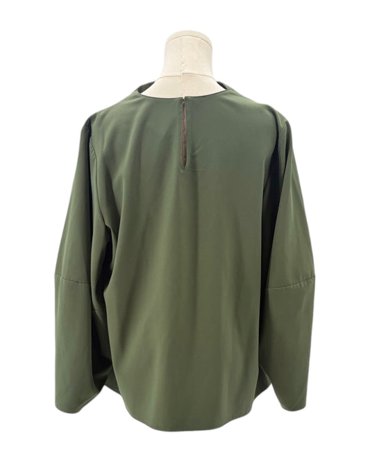 Green blouse on a mannequin against a white background