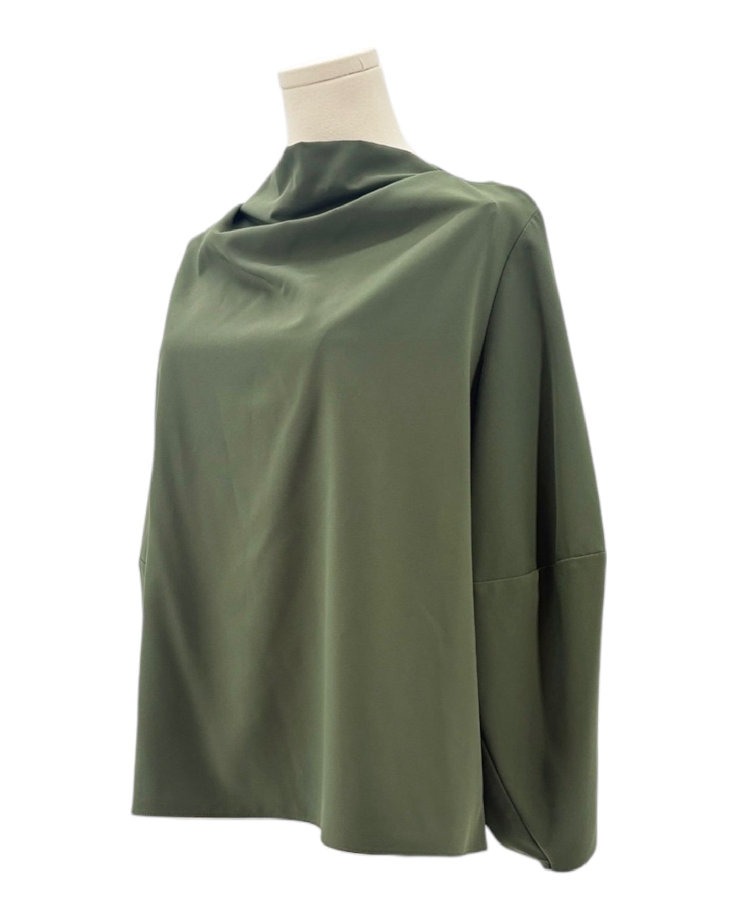 Green blouse on a mannequin against a white background
