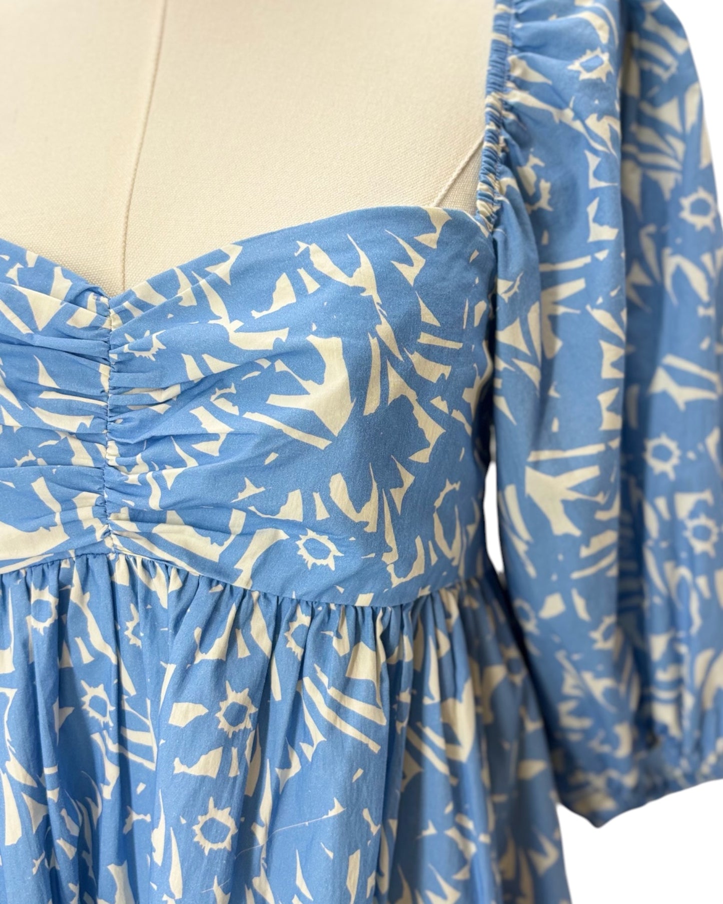 Blue dress with white pattern on a mannequin