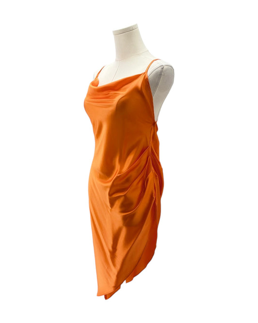 Orange dress on a mannequin against a white background